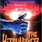 The Hitchhiker by R L Stine book cover, right hand with thumb raised up in front of two headlights