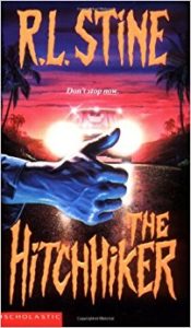 The Hitchhiker by R L Stine book cover, right hand with thumb raised up in front of two headlights