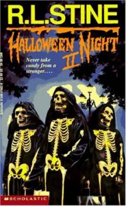 cover of Halloween Night II by R L Stine, has three figures dressed in skeleton outfits and black cloaks in front of a Halloween night background