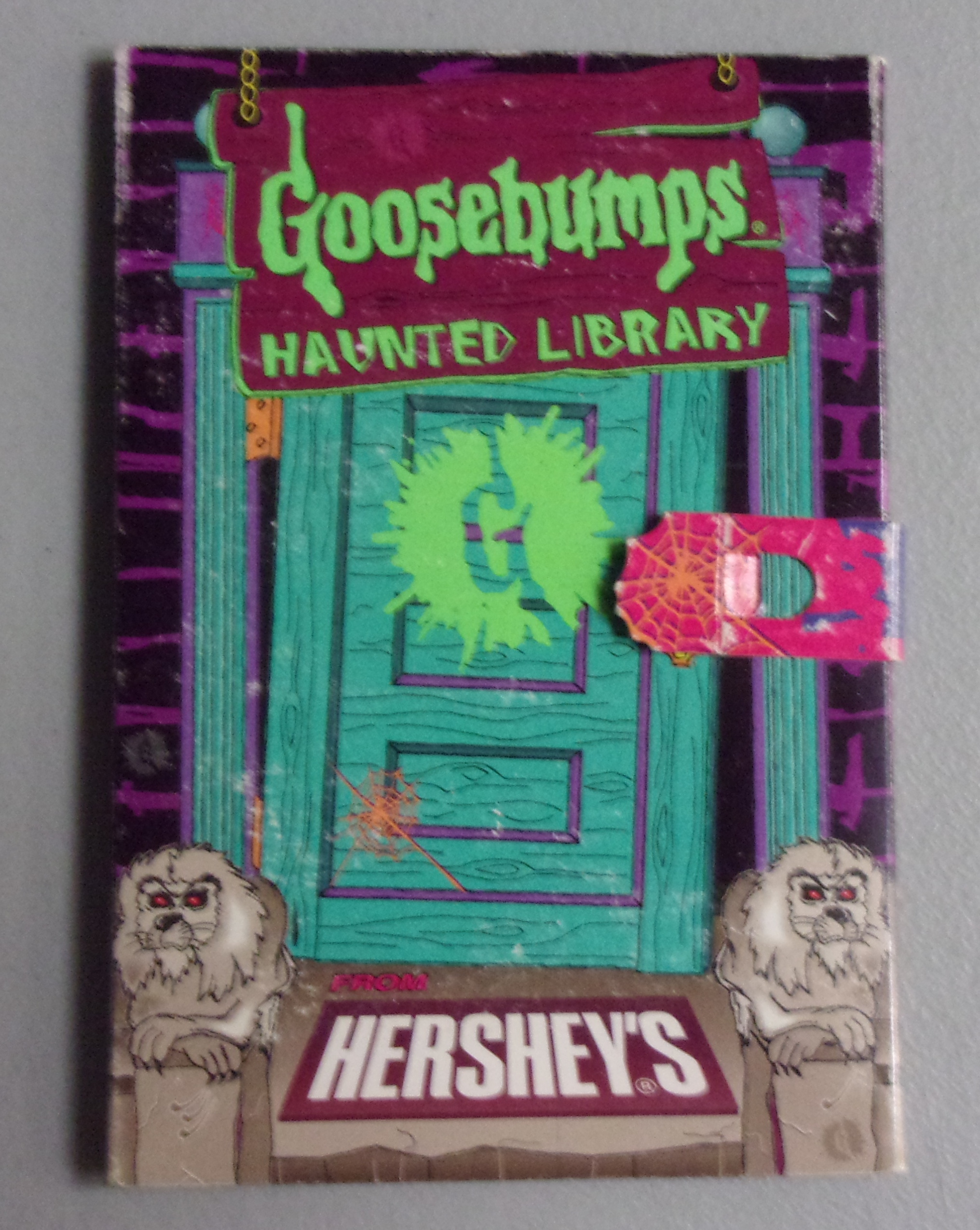 Cover of Goosebumps Haunted Library, door and Hershey's welcome mat with title information